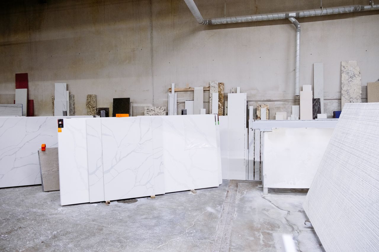 Granite and stone slabs in a manufacturing facility showing industrial processes.
